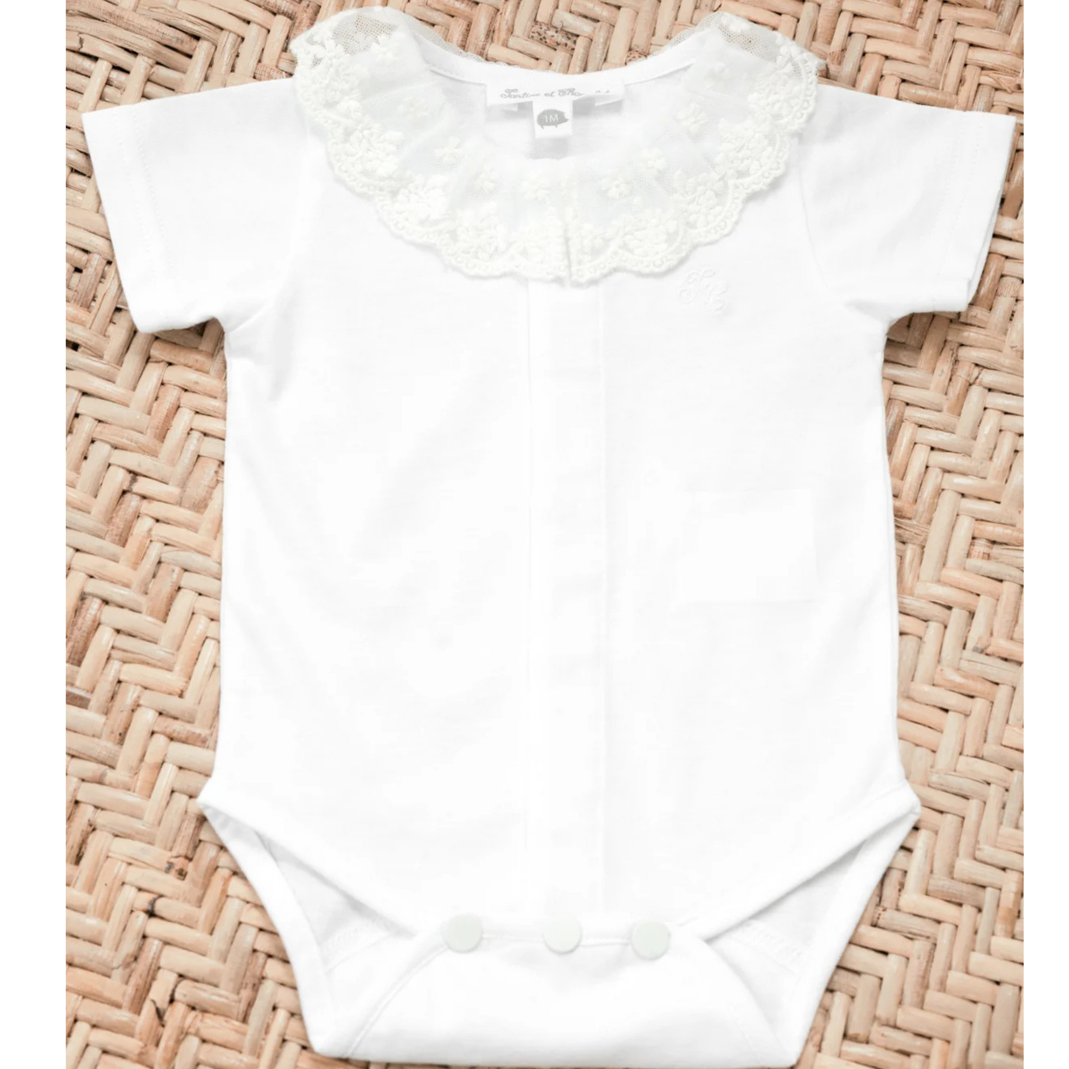 White baby jumpsuit with ruffle collar